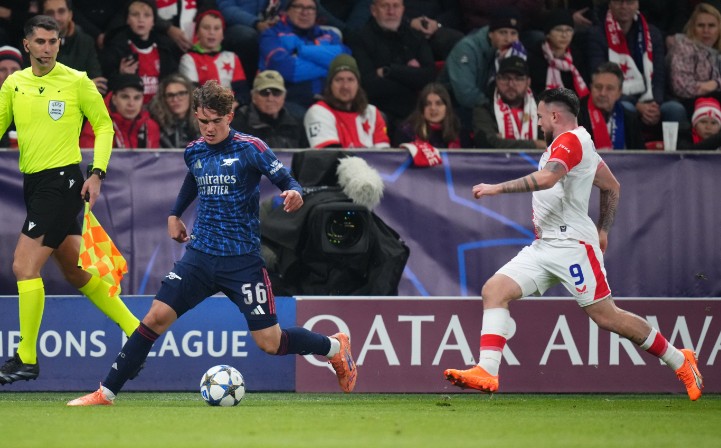 Arsenal's Max Dowman runs with the ball past Slavia Prague's Vasil Kusej. AP 