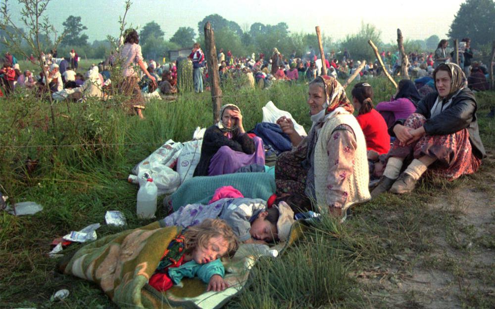 This July 14, 1995 file photo shows refugees from the overrun U.N. safe haven enclave of Srebrenica who had spent the night outdoors, gathering outside the U.N. base at Tuzla airport. U.N. judges on Tuesday, June 8, 2021 deliver their final ruling on the conviction of former Bosnian Serb army chief Radko Mladic on charges of genocide, war crimes and crimes against humanity during Bosnia’s 1992-95 ethnic carnage. This July 14, 1995 file photo shows refugees from the overrun U.N. safe haven enclave of Srebrenica who had spent the night outdoors, gathering outside the U.N. base at Tuzla airport. U.N. judges on Tuesday, June 8, 2021 deliver their final ruling on the conviction of former Bosnian Serb army chief Radko Mladic on charges of genocide, war crimes and crimes against humanity during Bosnia’s 1992-95 ethnic carnage.