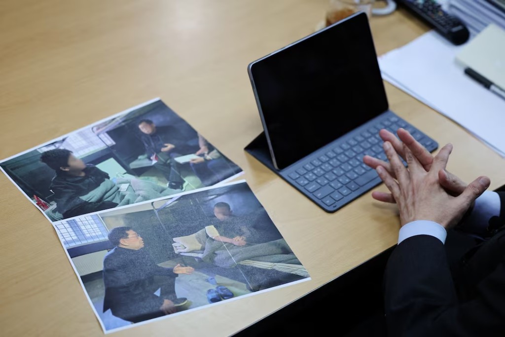 Lawmaker Yu Yong-weon of South Korea’s main opposition People Power Party explains pictures, showing two North Korean POWs who were recently transferred from Ukraine to South Korea, taken during his visit to a POW camp in Ukraine last February, at his office at the National Assembly in Seoul, South Korea, September 28, 2026. REUTERS/Kim Hong-Ji 