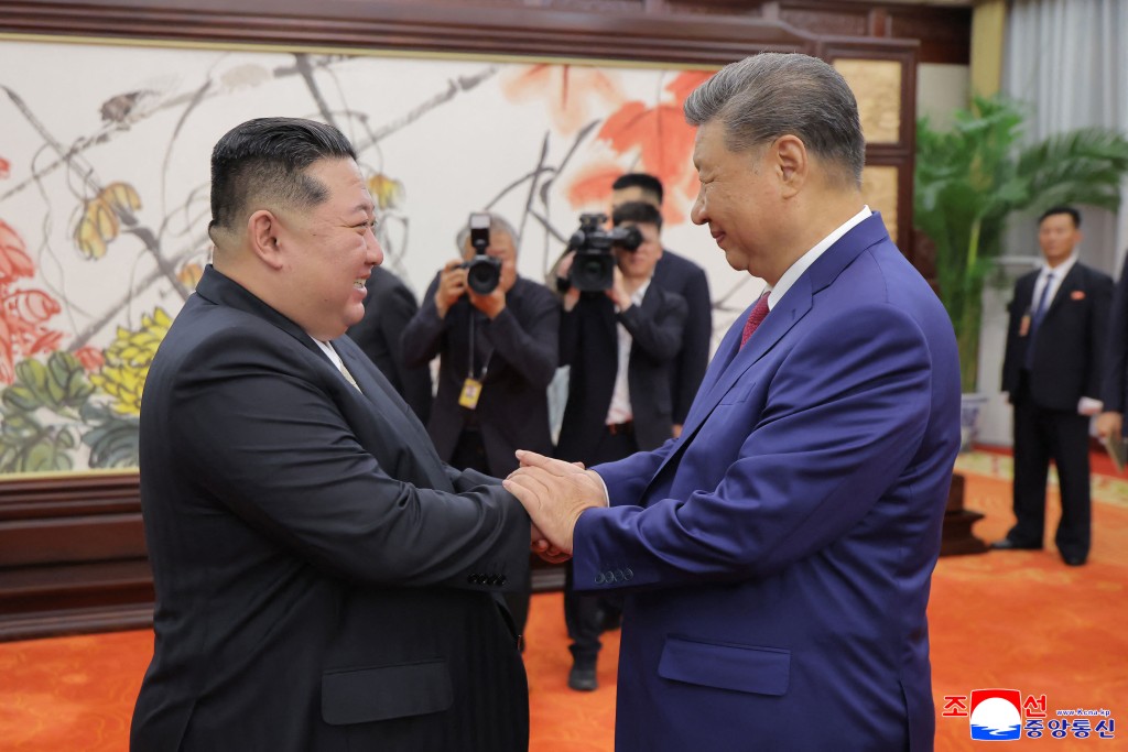 This picture taken on September 4, 2025 and released from North Korea's official Korean Central News Agency (KCNA) on September 5, 2025 shows North Korean leader Kim Jong Un (L) shaking hands with Chinese President Xi Jinping in Beijing. (Photo by KCNA VIA KNS / AFP)