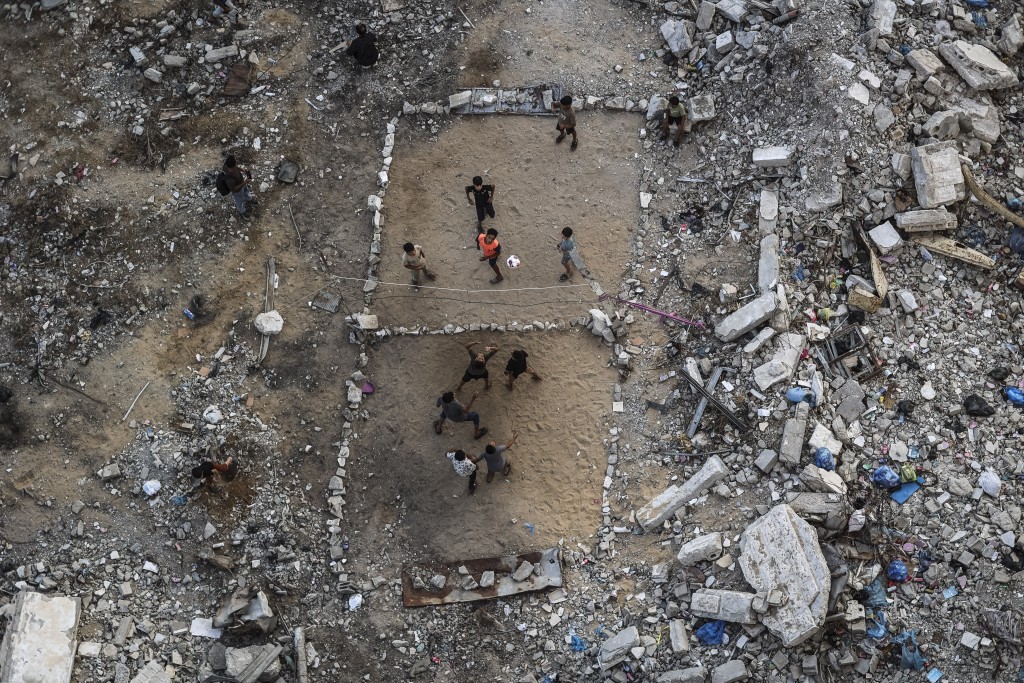Photo by OMAR AL-QATTAA / AFP  Palestinian children play volleyball on a makeshift court made of rubble in Gaza City on September 15, 2026.