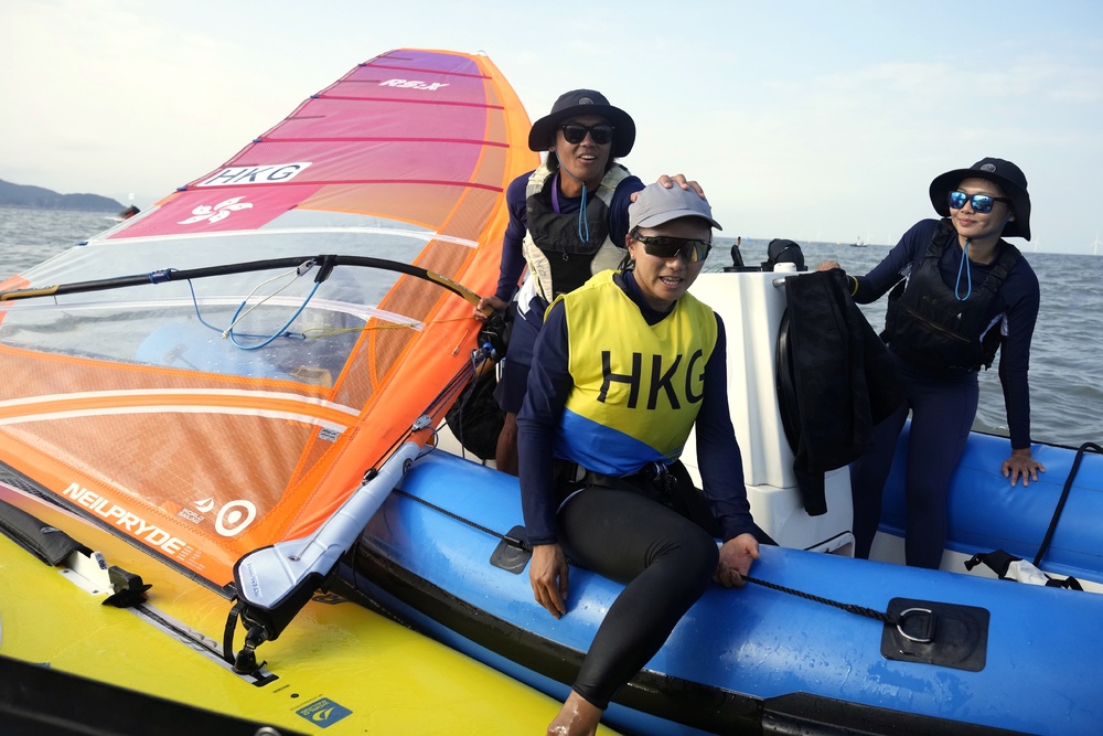 Ngai Wai-yan, left, wins a silver in windsurfing while the dressage team and women's rugby sevens team grab bronzes. AP, AFP, SF&OC