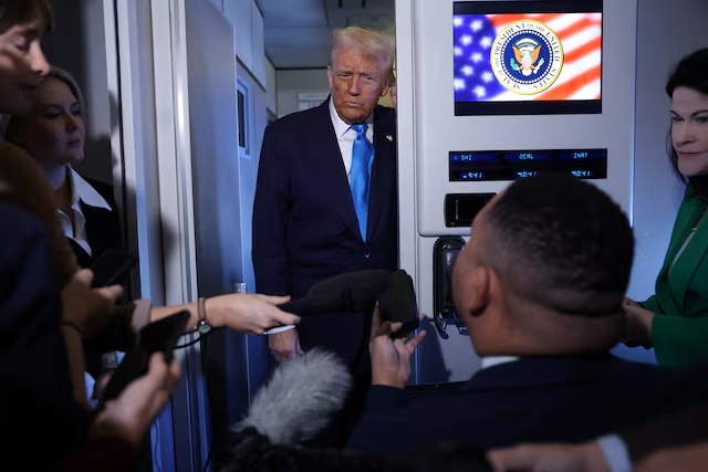 U.S. President Donald Trump listens as he meets with members of the media on board Air Force One en route to South Korea, October 29, 2025. REUTERS/Evelyn Hockstein