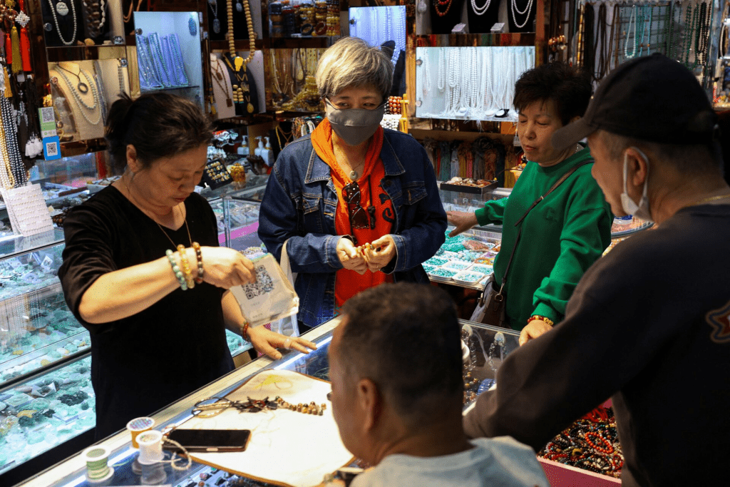 People shop at an accessory store in Fuyoumen Commercial Building in Shanghai, China April 16, 2025. REUTERS/Go Nakamura/File Photo