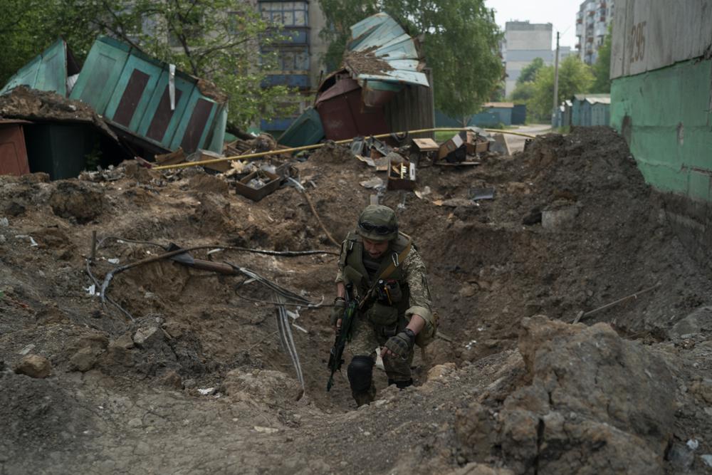 A special task force police officer inspects a site after an airstrike by Russian forces in Lysychansk, Luhansk. (AP) A special task force police officer inspects a site after an airstrike by Russian forces in Lysychansk, Luhansk. (AP)