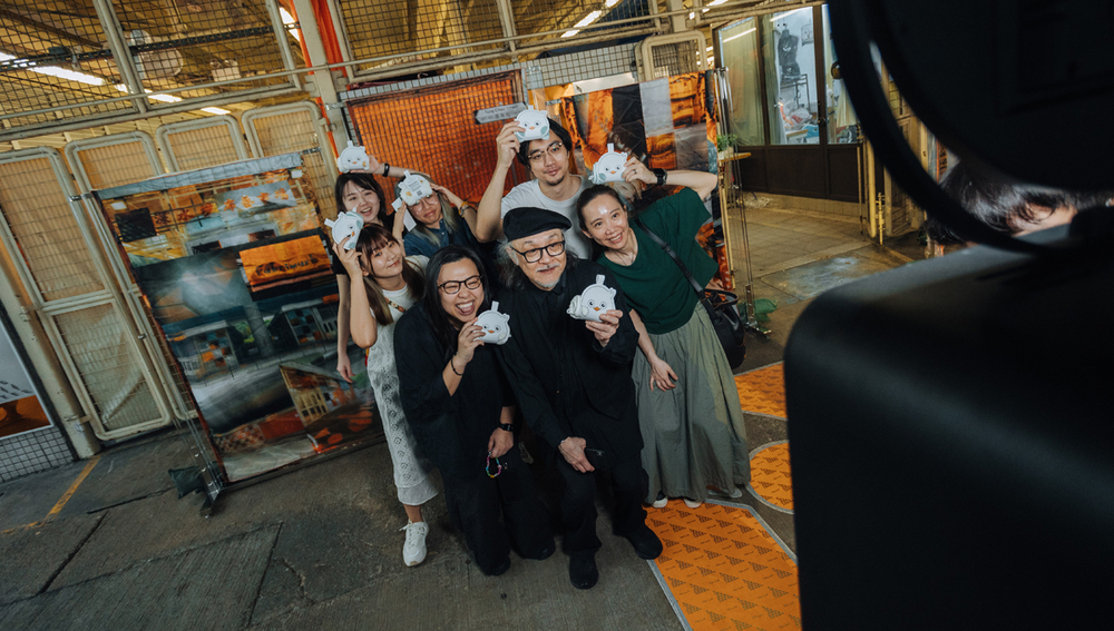 Guests strike a pose at the photo booth of the Fabrimark project.