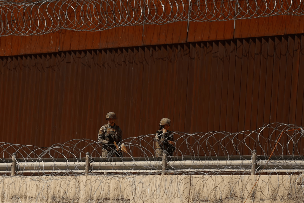 Texas National Guard soldiers walk near the U.S.-Mexico border wall, as seen from Ciudad Juarez, Mexico, March 11, 2025. REUTERS/Jose Luis Gonzalez/File Photo