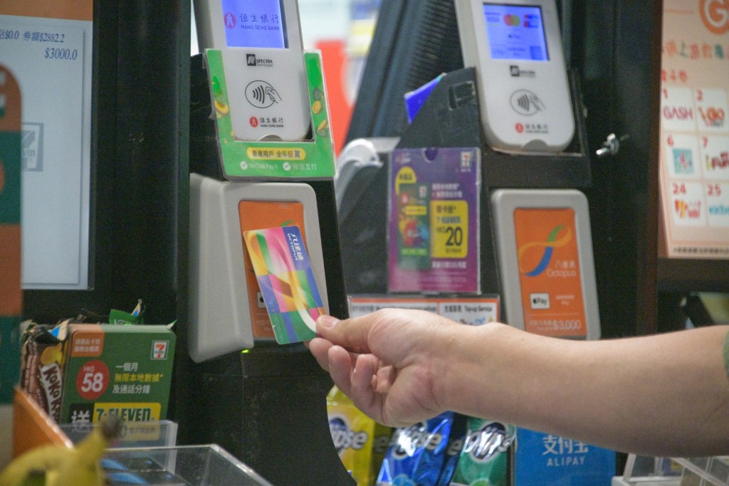 People scan Octopus card for payment. Singtao