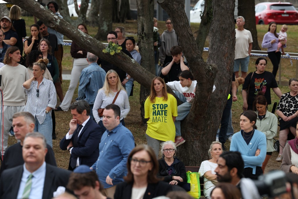 A woman wearing a t-shirt that reads ‘Stop Hate Mate’ attends a vigil to commemorate the victims of a mass shooting that targeted Jewish holiday celebration on Sunday, in Sydney, Australia, December 16, 2025. REUTERS/Hollie Adams