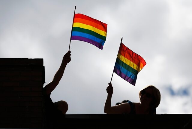 People hold pride flags during the Gay Pride parade in Toronto July 1, 2012. REUTERS/Mark Blinch 