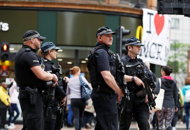 Armed police officers stand on duty in central Manchester, Britain, May 28, 2017. REUTERS/Phil Noble 