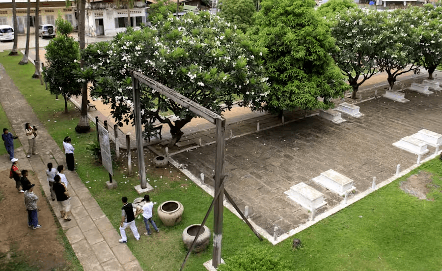 FILE - Tourists take their tour at the grave side in the former Pol Pot 's notorious S-21 prison, known Tuol Sleng genocide museum in Phnom Penh, Cambodia, Sunday, July 19, 2009. (AP Photo/Heng Sinith, File)
