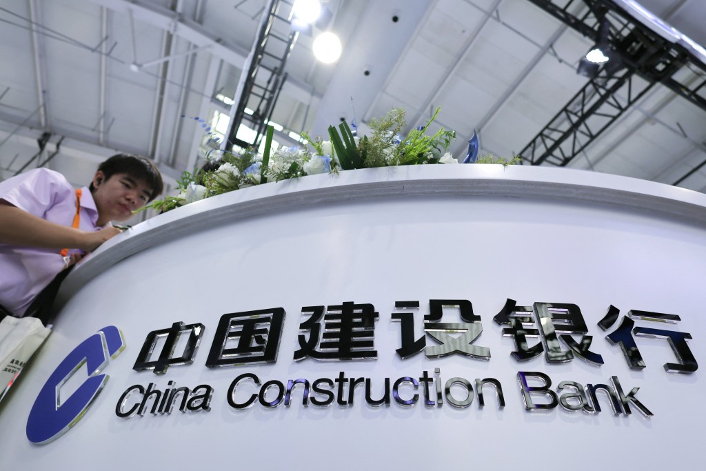 A visitor stands next to a logo of China Construction Bank (CCB) at China International Fair for Trade in Services (CIFTIS) in Beijing, China, September 10, 2025. REUTERS/Maxim Shemetov