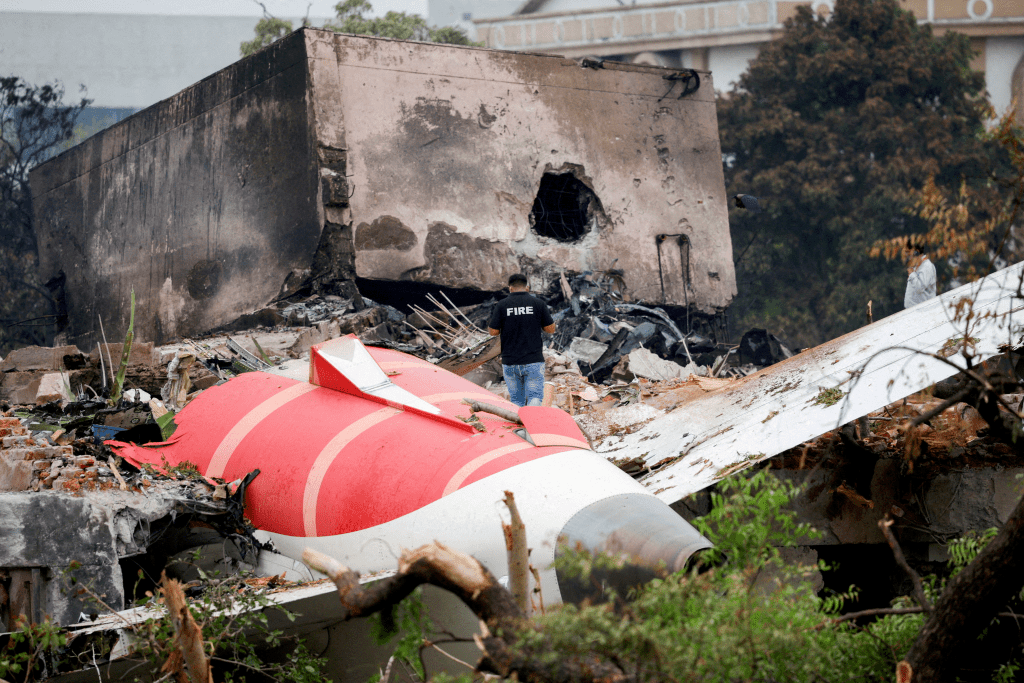 FILE PHOTO: A firefighter stands next to the crashed Air India Boeing 787-8 Dreamliner aircraft, in Ahmedabad, India, June 13, 2025. REUTERS/Adnan Abidi/File Photo