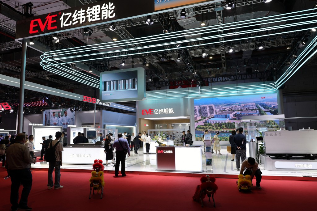 People visit the booth of lithium battery manufacturer EVE Energy during a media day for the Auto Shanghai show in Shanghai, China April 23, 2025. REUTERS/Go Nakamura