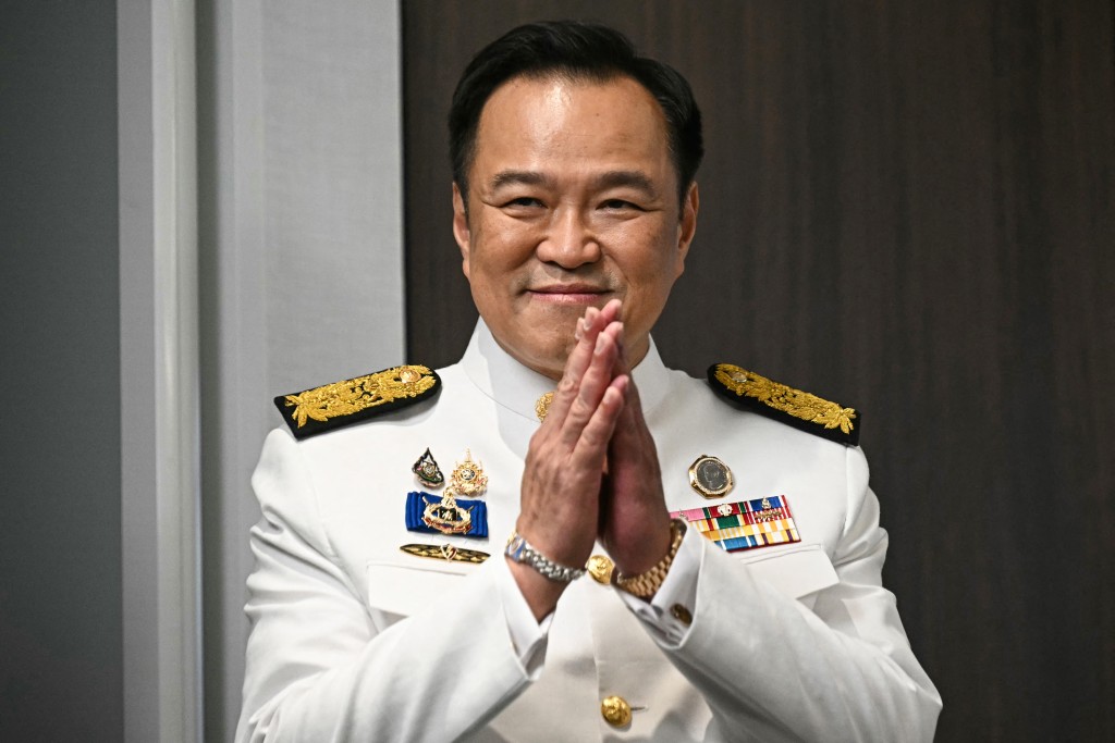 Thailand's new prime minister Anutin Charnvirakul greets media representatives as he arrives to deliver remarks after the royal endorsement ceremony, at the Bhumjaithai Party's headquarters in Bangkok on September 7, 2025. (AFP)