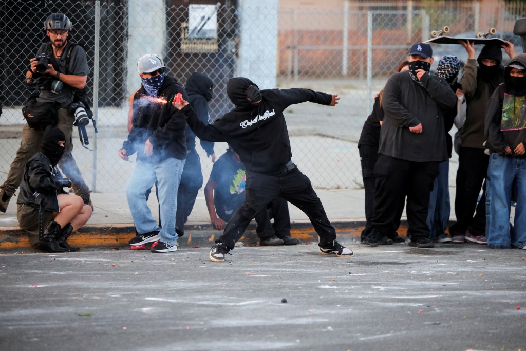 A protester throws a firework during a standoff between police and protesters following multiple detentions by Immigration and Customs Enforcement (ICE), in the Los Angeles County city of Paramount, California, U.S., June 7, 2025. (Reuters)