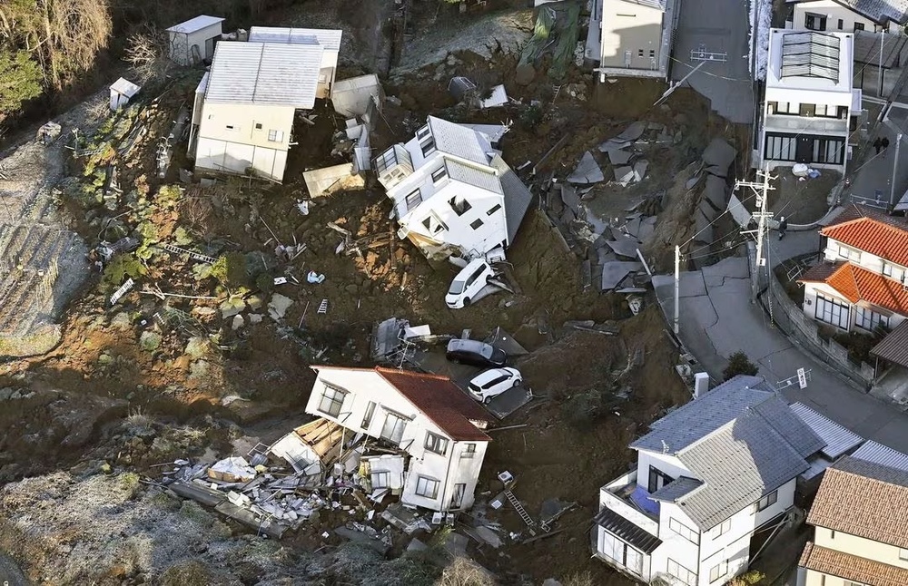 An aerial view shows collapsed houses, cars and roads caused by an earthquake in Kanazawa, Ishikawa prefecture, Japan January 2, 2024, in this photo released by Kyodo. Mandatory credit Kyodo/via REUTERS An aerial view shows collapsed houses, cars and roads caused by an earthquake in Kanazawa, Ishikawa prefecture, Japan January 2, 2024, in this photo released by Kyodo. Mandatory credit Kyodo/via REUTERS