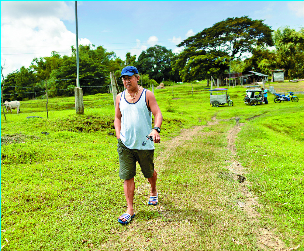 Glenn Madoginog on his farm in Nueva Ecija province, north of Manila.David Ledoux shows photos of Indonesian navy officers aboard his ship. Glenn Madoginog on his farm in Nueva Ecija province, north of Manila.David Ledoux shows photos of Indonesian navy officers aboard his ship.