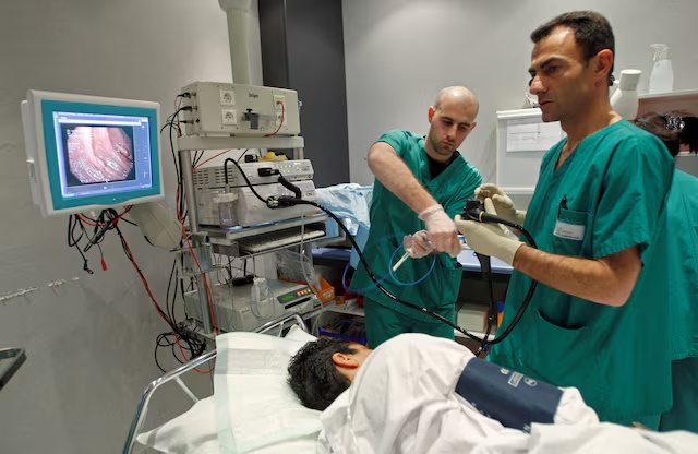 A French doctor performs a colonoscopy on a patient at the Ambroise Pare hospital in Marseille, March 25, 2008. REUTERS/Jean-Paul Pelissier (FRANCE)/File Photo