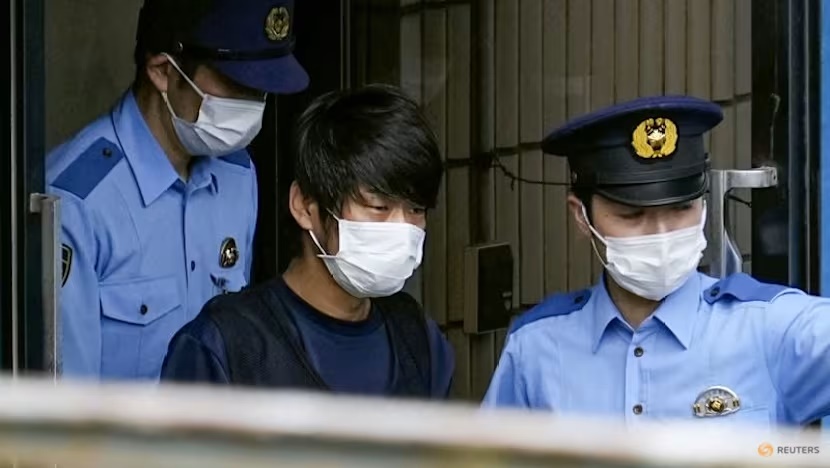 Tetsuya Yamagami, suspected of killing former Japanese premier Shinzo Abe, is escorted by police officers as he is taken to prosecutors, at Nara-nishi police station in Nara, western Japan, in this photo taken by Kyodo on Jul 10, 2022. (File photo: Kyodo via Reuters)