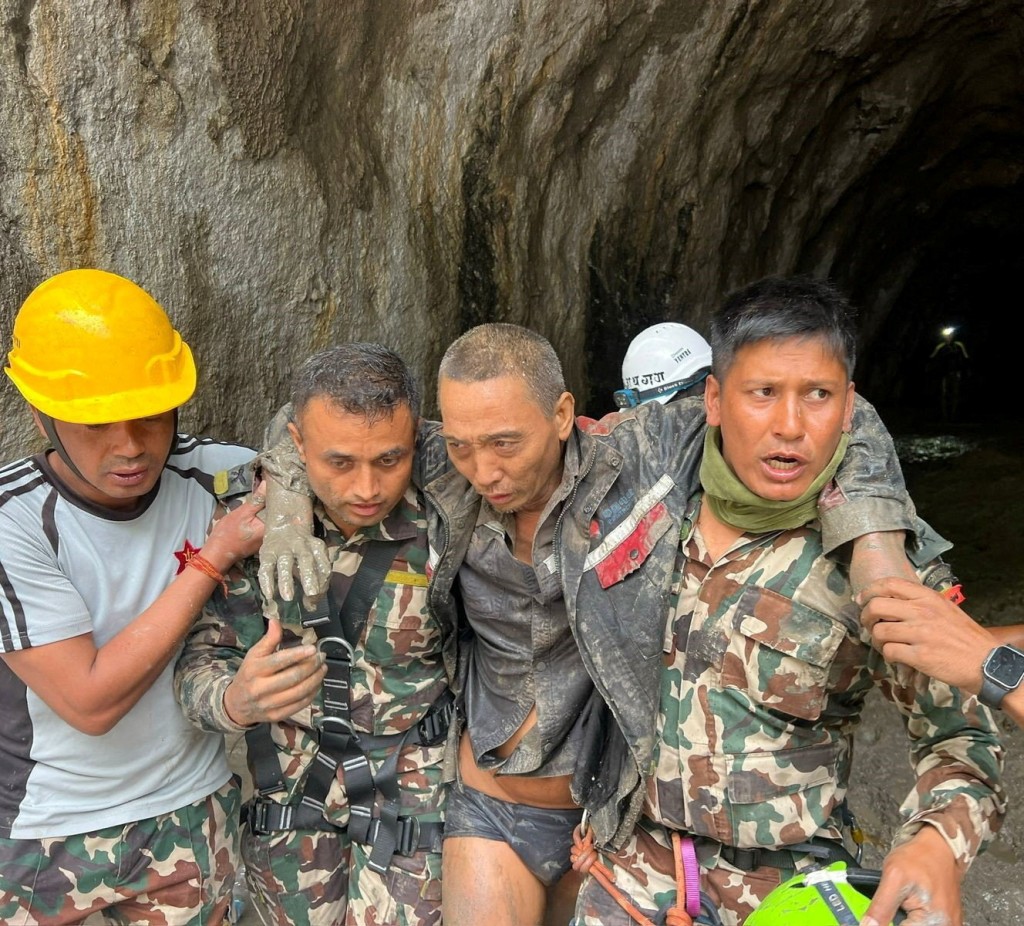 Members of the Nepal Army search and rescue team carry a Chinese national after he was rescued alive from a tunnel at the Upper Trishuli-1 Hydropower Project following devastating floods and mudslides, in Rasuwa, Nepal, September 5, 2026. Nepal Army/Handout via REUTERS.