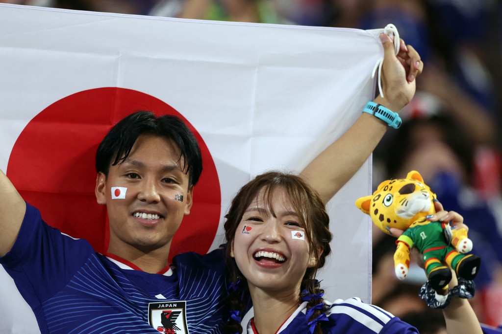 Japanese fans cheer from the stands during the 2026 World Cup Group F football match between Tunisia and Japan (AFP)