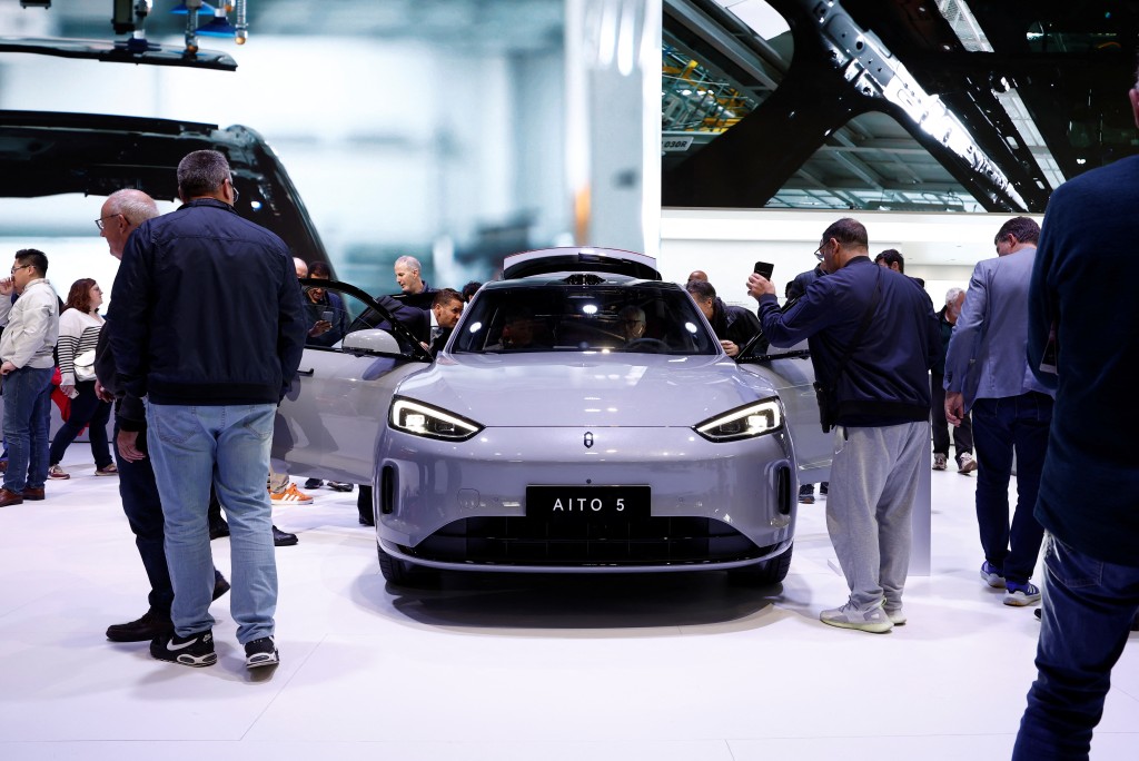 Visitors inspect a Huawei Aito M5 at the 2024 Paris Auto Show in Paris, France, October 15, 2024. REUTERS/Benoit Tessier
