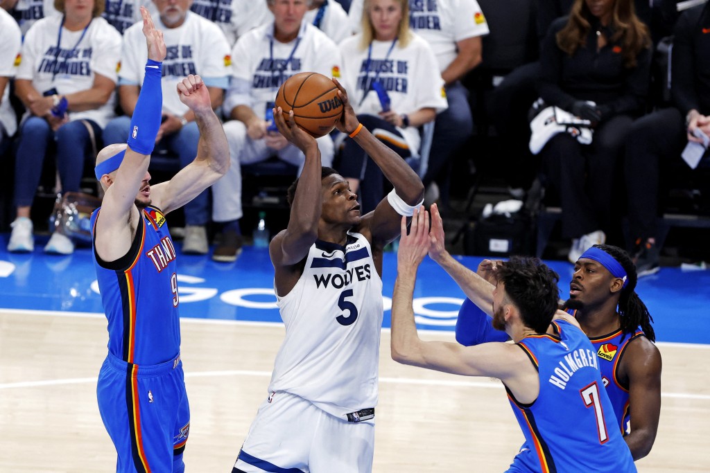 Minnesota Timberwolves guard Anthony Edwards (5) drives to the basket against Oklahoma City Thunder guard Alex Caruso (9) during the third quarter in game five of the western conference finals. (Reuters)