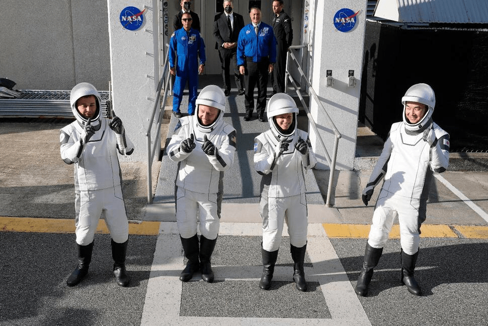 Astronauts, from left, Oleg Platonov, of Russia, Mike Fincke, Zena Cardman, and Kimiya Yui, of Japan, pose for a photo as they leave the Operations and Checkout Building for a trip the Kennedy Space Center's Launch Pad 39-A and a planned liftoff on a SpaceX Falcon 9 rocket Friday, Aug. 1, 2025, in Cape Canaveral , Fla. (AP Photo/John Raoux)