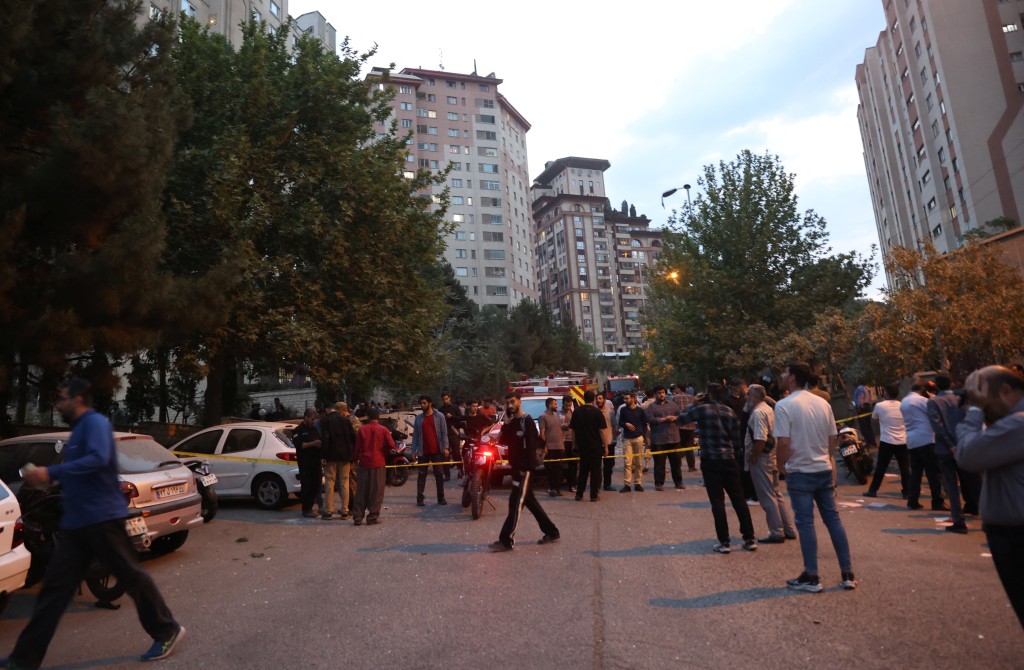 People gather in the street in the aftermath of Israeli strikes, in Tehran, Iran, June 13, 2025. (Majid Asgaripour/WANA via REUTERS)
