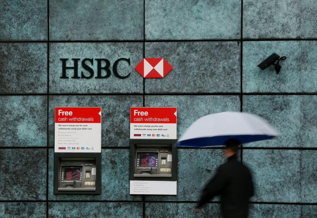 A man walks past a HSBC bank branch in the City of London, Britain November 12, 2014. REUTERS