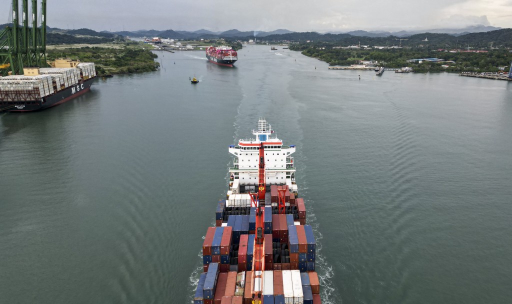 Photo by MARTIN BERNETTI / AFP This aerial view shows two cargo ships sailing out of the Panama Canal on the Pacific side in Panama City on October 6, 2025.