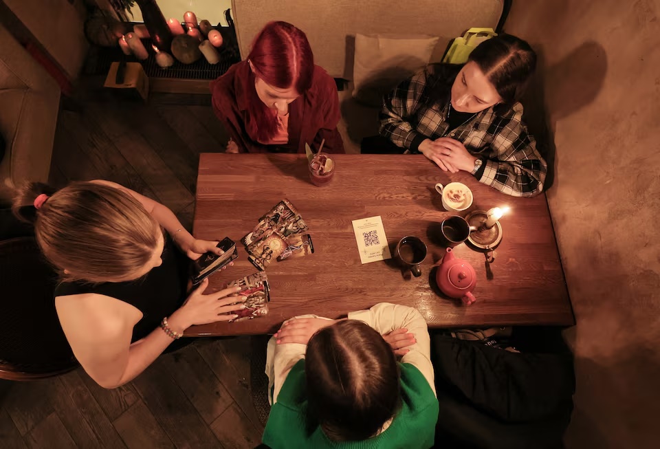 Fortune teller Arina Frants lays out Tarot cards on a table in the voodoo-themed bar Marie Laveau in Moscow, Russia, February 17, 2026. REUTERS/Shamil Zhumatov