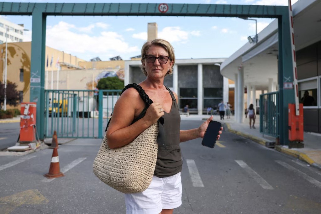 Svetlana Grkovic Maksimovic, wife of a Ryanair passenger partially sucked out of a broken window on a flight from Greece to Germany, stands in front of AHEPA hospital where her husband is hospitalised, in Thessaloniki, Greece, July 14, 2026. REUTERS/Alexandros Avramidis