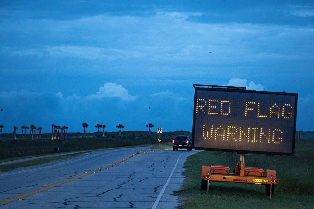 Illustration: A red flag warning sign on a North Padre Island beach access road ahead of Hurricane Beryl's landfall in Corpus Christi, Texas, US, on Sunday, July 7, 2024. (Bloomberg) Illustration: A red flag warning sign on a North Padre Island beach access road ahead of Hurricane Beryl's landfall in Corpus Christi, Texas, US, on Sunday, July 7, 2024. (Bloomberg)