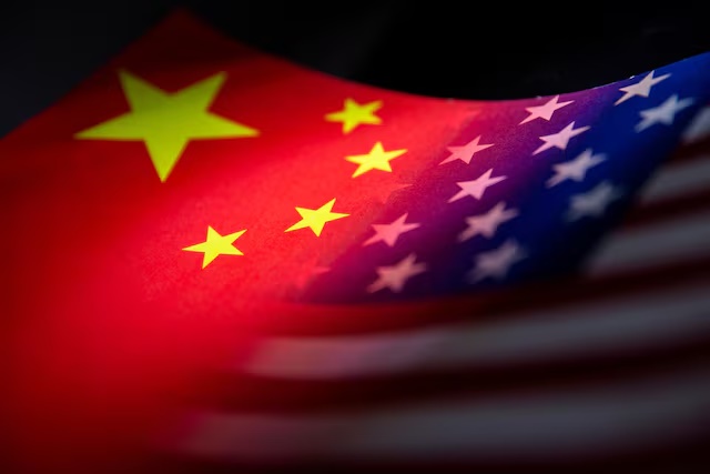 China's and U.S.' flags are seen printed on paper in this illustration taken January 27, 2022. REUTERS/Dado Ruvic/Illustration