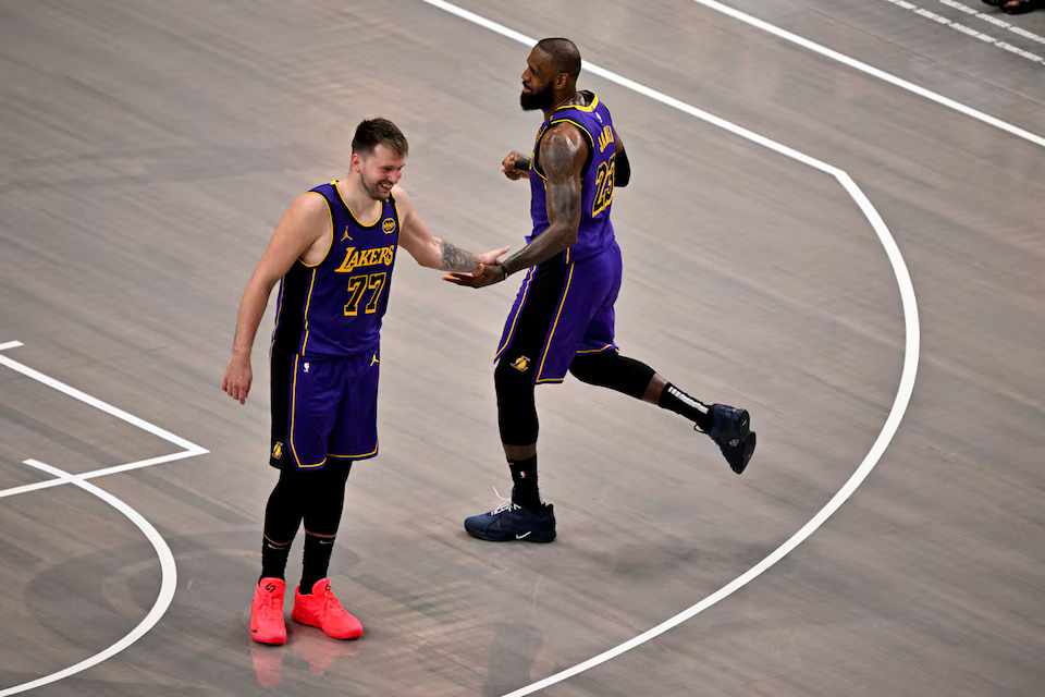 Apr 9, 2025; Dallas, Texas, USA; Los Angeles Lakers guard Luka Doncic (77) and Lakers forward LeBron James (23) celebrate during the fourth quarter against the Dallas Mavericks at the American Airlines Center. Mandatory Credit: Jerome Miron-Imagn Images