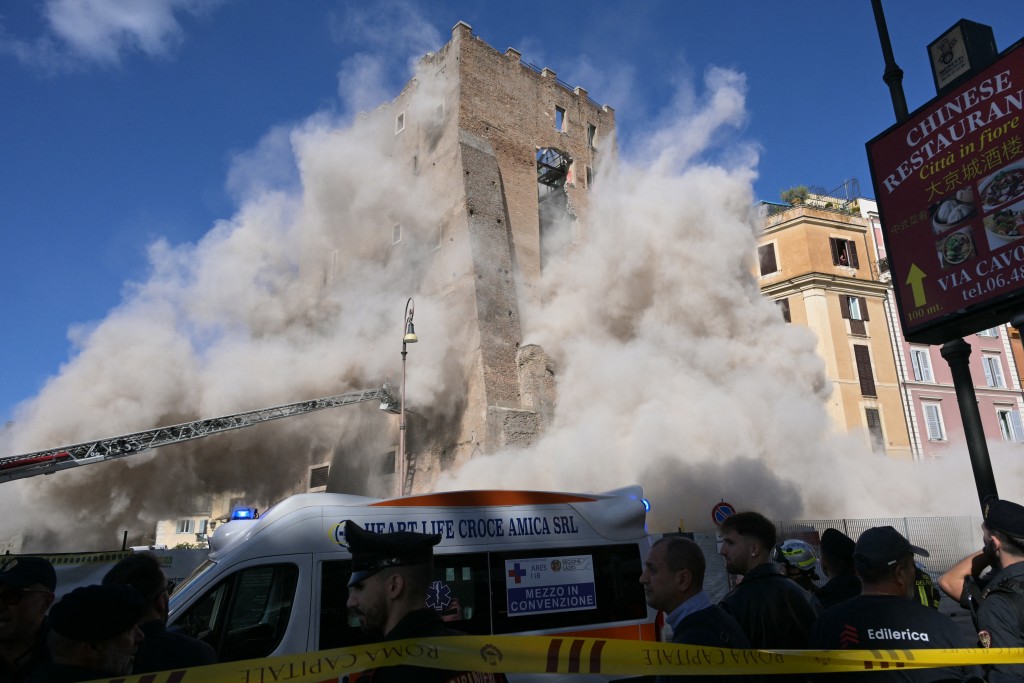 Dust rises due to a second collapse of part of the medieval tower "Torre dei Conti" near the Roman Forum in the historic center of Rome on November 3, 2025. (Photo by Tiziana FABI / AFP)