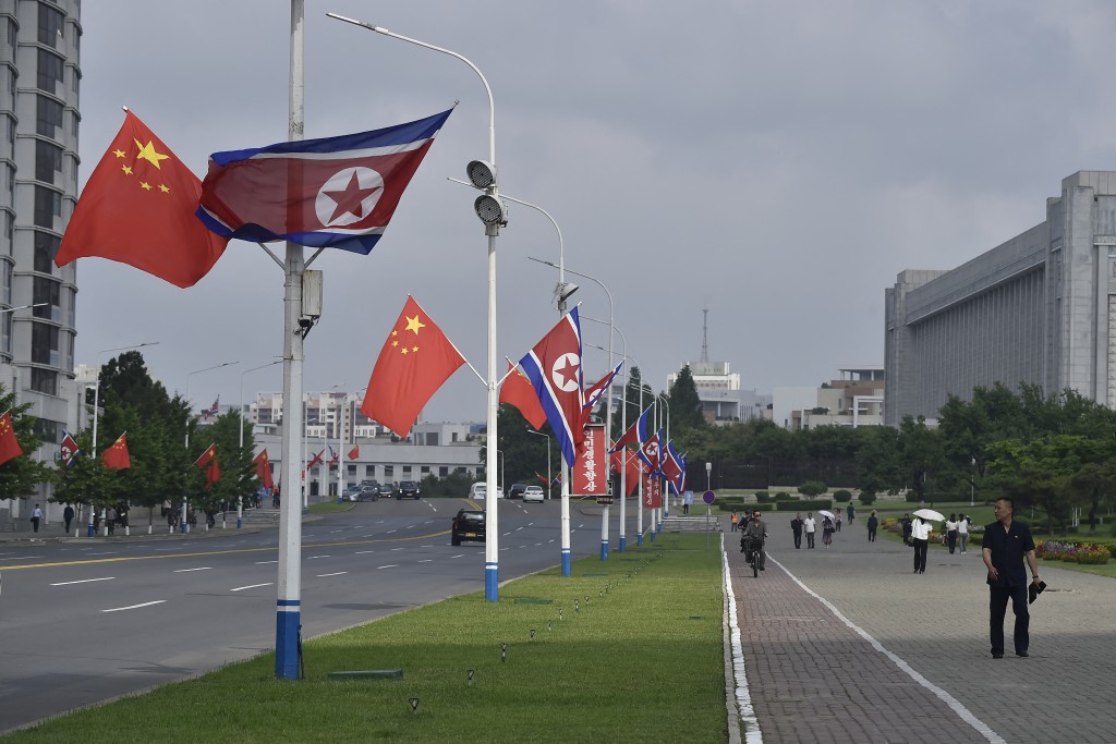 The national flags of North Korea and China are displayed on a street in Pyongyang on June 8, 2026.
