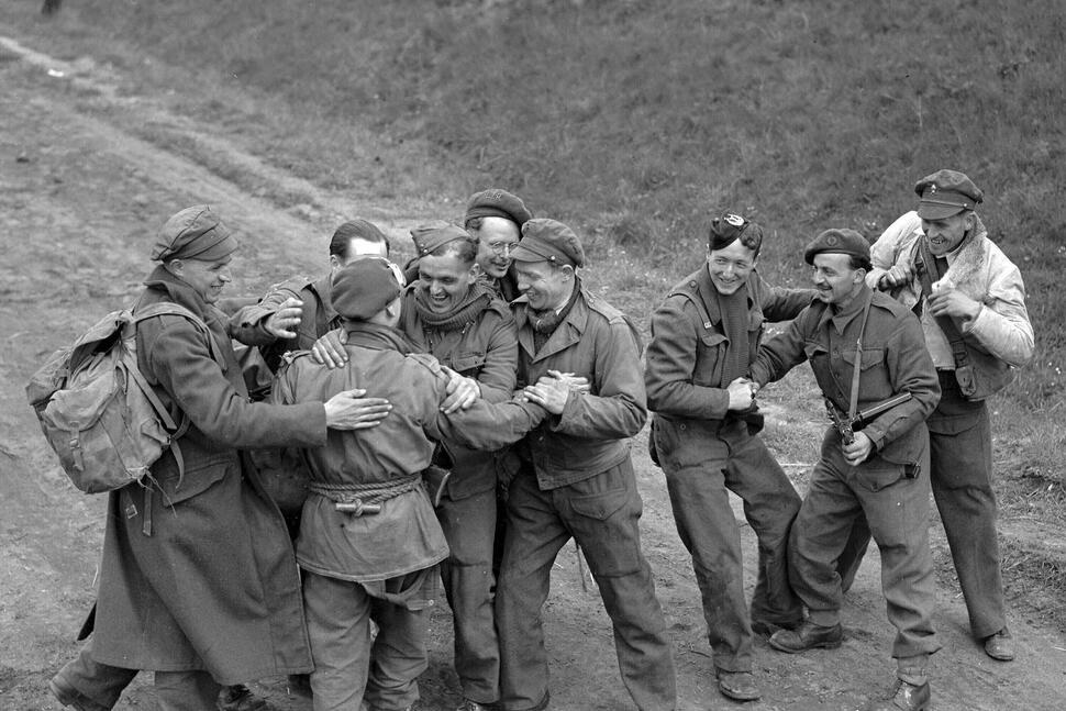 FILE - Recently released British prisoners of war meet up with a parachute recce party while marching towards Allied lines, in Germany May 4, 1945. German authorities have recently released 8,000 British prisoners of war. (AP Photo/Eddie Worth, File)