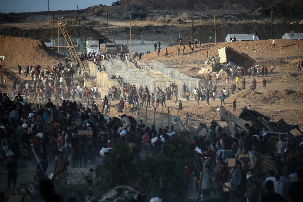 Palestinians gather at an aid distribution point set up by GHF, near the Nuseirat refugee camp in the central Gaza Strip on June 25, 2025. (AFP)
