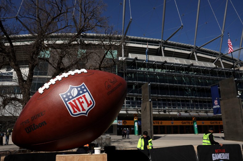 Construction workers put up signs at the Melbourne Cricket Ground ahead of the first-ever regular-season NFL game in Australia, featuring the San Francisco 49ers and the Los Angeles Rams. AFP