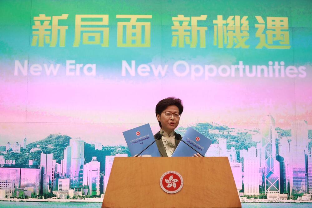 Carrie Lam holds up copies of the sky-blue policy address she will deliver today. Sing Tao Carrie Lam holds up copies of the sky-blue policy address she will deliver today. Sing Tao