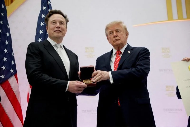FILE PHOTO: US President Donald Trump presents the National Medal of Science to Tesla and SpaceX CEO Elon Musk during the "A New Golden Age" summit at the U.S. Institute of Peace, renamed The Donald J. Trump Institute of Peace by the Trump administration, in Washington, DC, US, October 8, 2026. REUTERS/Evan Vucci/File Photo