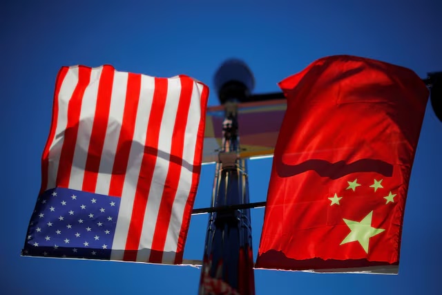 The flags of the United States and China fly from a lamppost in the Chinatown neighborhood of Boston, Massachusetts, U.S., November 1, 2021. REUTERS/Brian Snyder