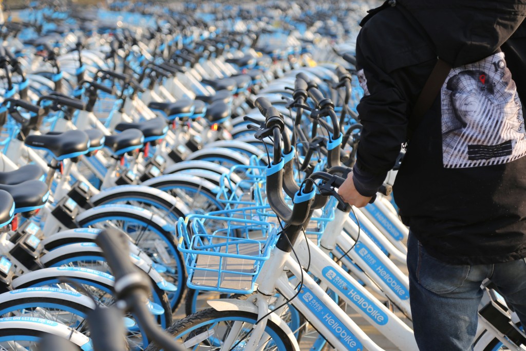 Bicycles of bike-sharing firm Hellobike are seen outside a subway station in Zhengzhou, Henan province, China March 13, 2018. Picture taken March 13, 2018. REUTERS