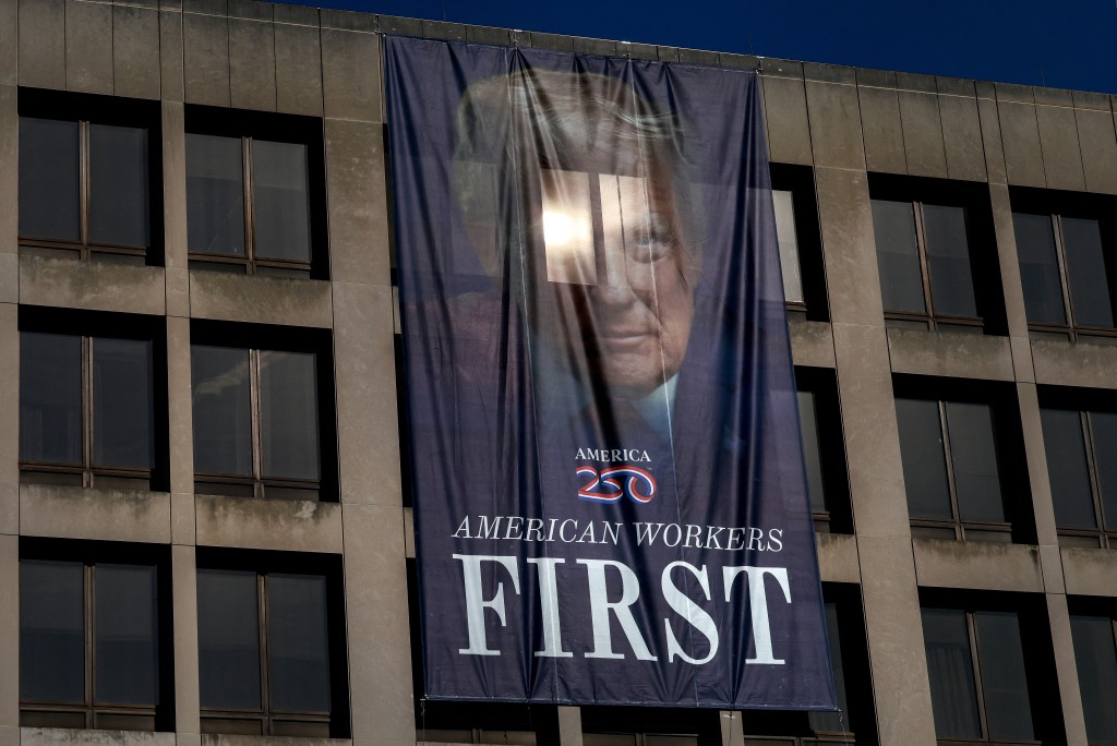 A banner featuring U.S. President Donald Trump hangs over the U.S. Department of Labor, which published its weekly initial jobless claims report for the week ending January 3, in Washington, D.C., U.S., January 8, 2026. REUTERS/Evelyn Hockstein