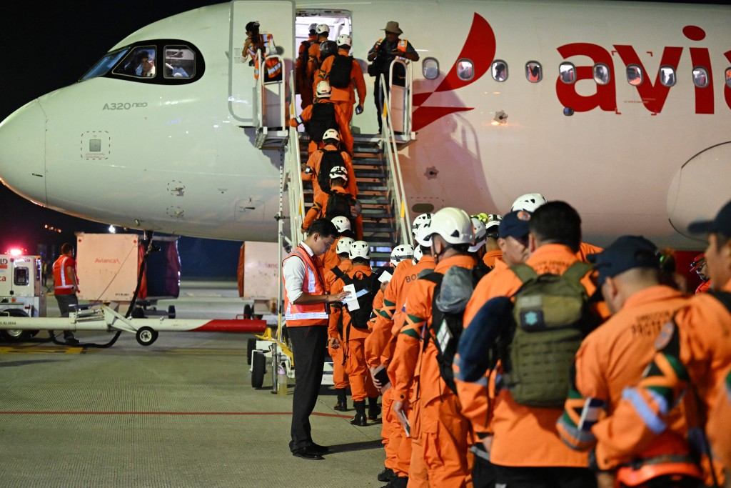 Photo by MARVIN RECINOS / AFP. Members of the General Directorate of Civil Protection of El Salvador (DGPC) board a plane with humanitarian aid bound for Jamaica, ordered by El Salvador's President Nayib Bukele, after the passage of Hurricane Melissa, at the tarmac of San Oscar Romero International Airport in San Luis Talpa, El Salvador on October 31, 2025.