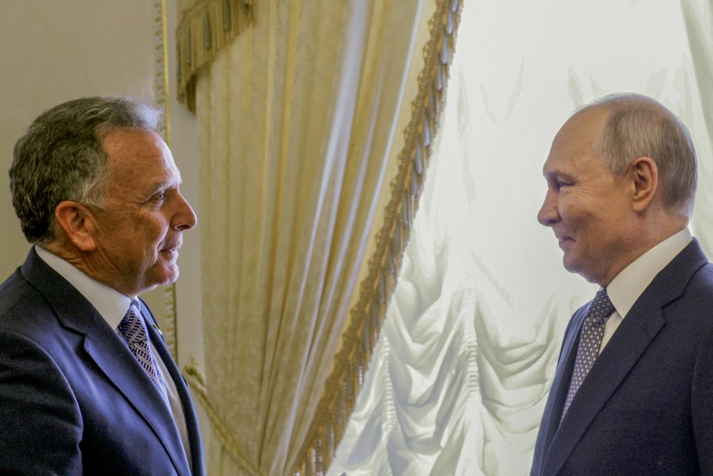In this pool photograph distributed by the Russian state agency Sputnik, Russia's President Vladimir Putin (R) greets US special envoy Steve Witkoff (L) during their meeting in Saint Petersburg on October 21, 2026. (Photo by Gavriil GRIGOROV / POOL / AFP)